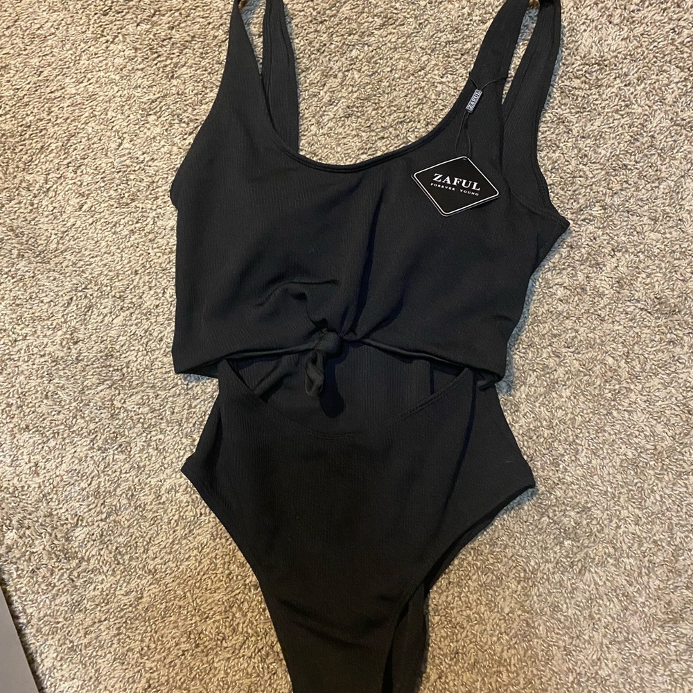 Black one piece with open front.